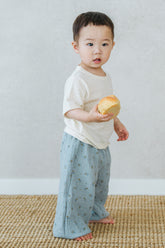 Toddler boy wearing Avauma Breeze Jogger Pants - deepblue flower, holding a toy while standing.